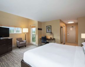 King bed with TV, terrace, workdesk and private bathroom at Hilton Whistler Resort & Spa.