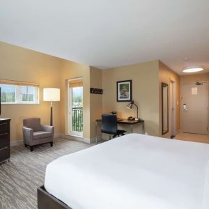 King bed with TV, terrace, workdesk and private bathroom at Hilton Whistler Resort & Spa.