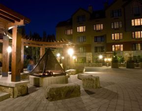 Hotel outdoor with fire place at Hilton Whistler Resort & Spa.