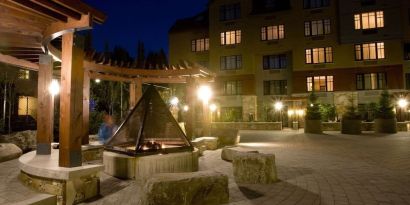 Hotel outdoor with fire place at Hilton Whistler Resort & Spa.