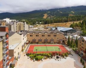 Hotel outdoor with tennis courtyard and lounge area at Hilton Whistler Resort & Spa.