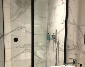 Guest bathroom with shower at Euston Square Hotel.