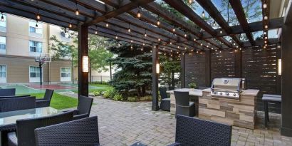 Hotel patio and outdoor lounge area at Homewood Suites By Hilton Burlington.