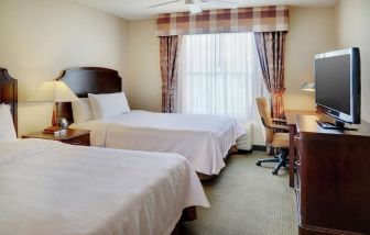 Day use twin room with TV and work desk at Homewood Suites By Hilton Burlington.