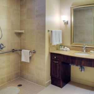 Guest bathroom with shower and toiletries at Homewood Suites By Hilton Burlington.