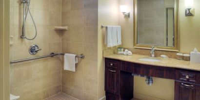 Guest bathroom with shower and toiletries at Homewood Suites By Hilton Burlington.