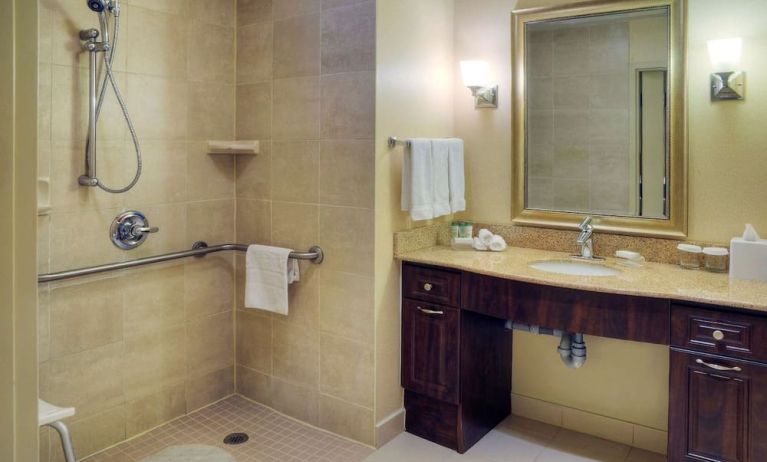 Guest bathroom with shower and toiletries at Homewood Suites By Hilton Burlington.