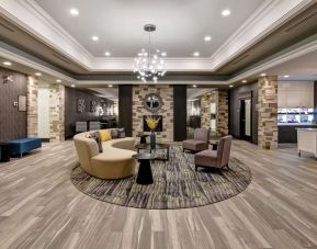 Hotel lobby with lounge area at Homewood Suites By Hilton Burlington.