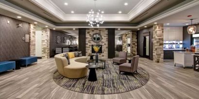 Hotel lobby with lounge area at Homewood Suites By Hilton Burlington.