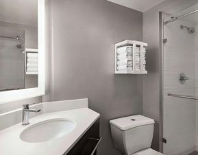 Guest bathroom with shower at Hampton Inn Chicago O`Hare.