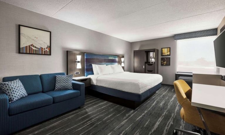 Spacious day use room with sofa and work desk at Hampton Inn Chicago O`Hare.