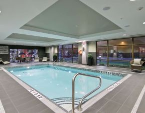 Indoor pool with lounge area where to relax after a busy working day at the Hampton Inn by Hilton Toronto Markham.