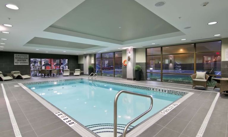 Indoor pool with lounge area where to relax after a busy working day at the Hampton Inn by Hilton Toronto Markham.