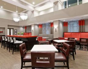 Dining area with comfortable seating, perfect for co-working at the Hampton Inn & Suites by Hilton Toronto Markham.