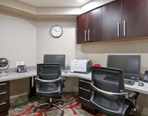 Business center with desk computers, printer, telephones and comfortable mobiliary at the Hampton Inn & Suites by Hilton Toronto Markham.