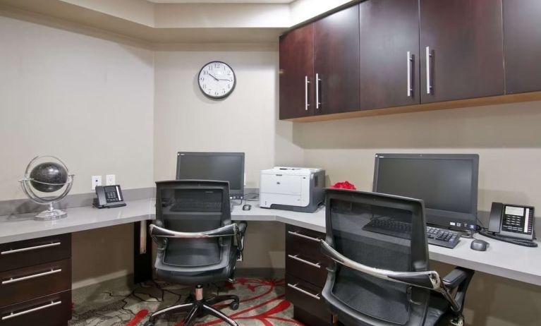 Business center with desk computers, printer, telephones and comfortable mobiliary at the Hampton Inn & Suites by Hilton Toronto Markham.