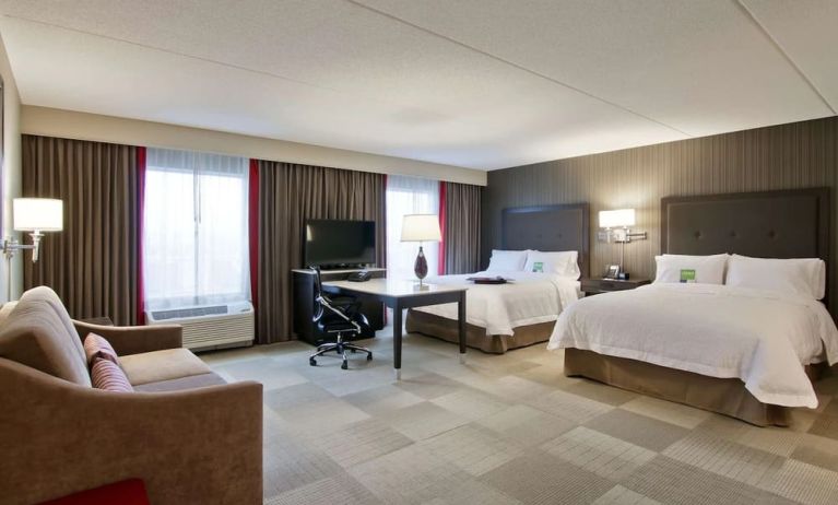 Bright and spacious day use twin room with work desk, TV, sofa and private bathroom at the Hampton Inn & Suites by Hilton Toronto Markham.