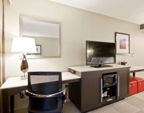 In-room workstation with TV, microwave and mini bar at the Hampton Inn & Suites by Hilton Toronto Markham.