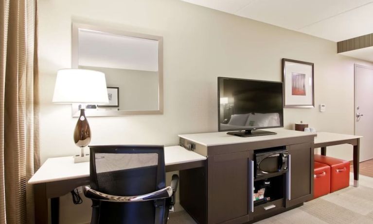 In-room workstation with TV, microwave and mini bar at the Hampton Inn & Suites by Hilton Toronto Markham.