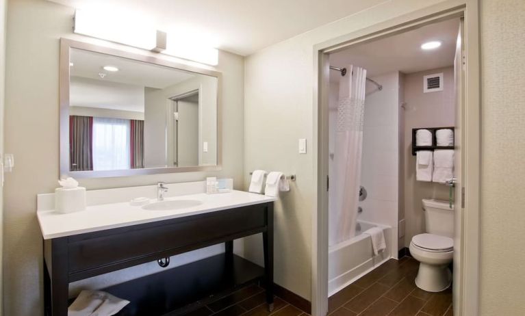 Guest bathroom with toiletries and tub at the Hampton Inn & Suites by Hilton Toronto Markham.