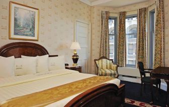 King bedroom with desk at Congress Plaza Hotel.