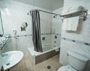 Guest bathroom with shower and tub at Congress Plaza Hotel.