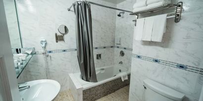 Guest bathroom with shower and tub at Congress Plaza Hotel.