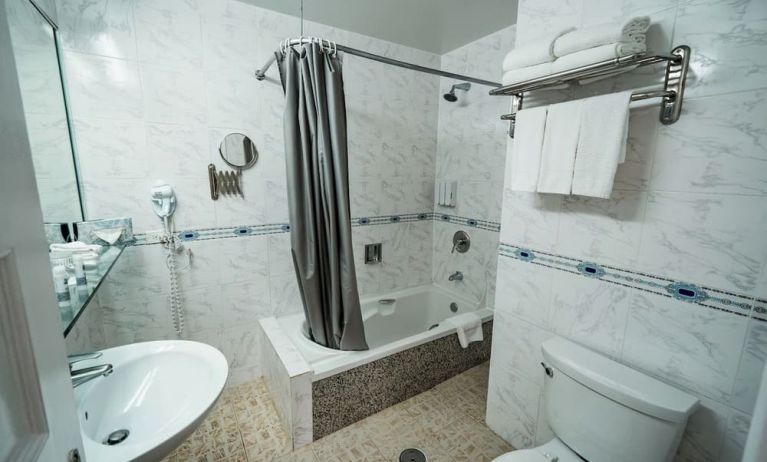 Guest bathroom with shower and tub at Congress Plaza Hotel.