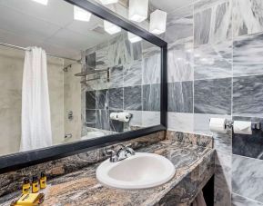 Guest bathroom with shower at Best Western Plus Newark Airport West.