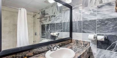 Guest bathroom with shower at Best Western Plus Newark Airport West.