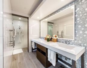 Guest bathroom with shower at Shade Hotel Manhattan Beach.