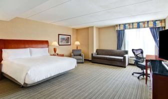 Day use room with TV, work desk, and sofa at Hilton Garden Inn Toronto/Burlington.