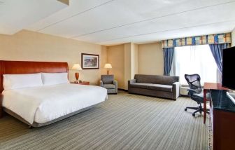 Day use room with TV, work desk, and sofa at Hilton Garden Inn Toronto/Burlington.