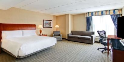 Day use room with TV, work desk, and sofa at Hilton Garden Inn Toronto/Burlington.