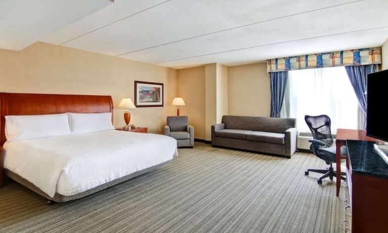 Day use room with TV, work desk, and sofa at Hilton Garden Inn Toronto/Burlington.