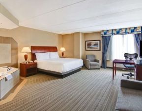 Day use room with TV, work desk, sofa and tub at Hilton Garden Inn Toronto/Burlington.