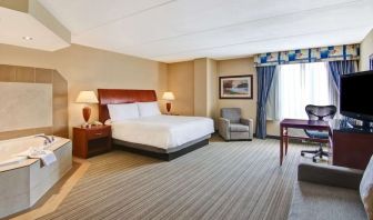 Day use room with TV, work desk, sofa and tub at Hilton Garden Inn Toronto/Burlington.