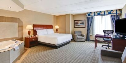 Day use room with TV, work desk, sofa and tub at Hilton Garden Inn Toronto/Burlington.