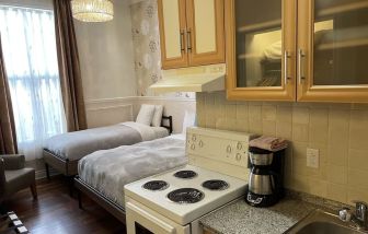 Twin room with in-room kitchen at Parc Suites Hotel.