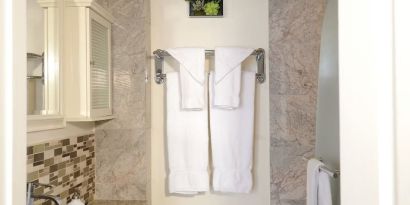 Private guest bathroom with shower at Parc Suites Hotel.