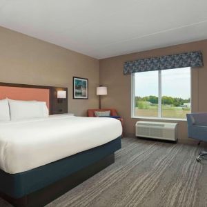 Bright day use king room with TV and work desk at Hampton Inn By Hilton Port Hope.