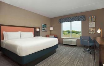 Bright day use king room with TV and work desk at Hampton Inn By Hilton Port Hope.