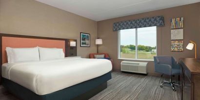 Bright day use king room with TV and work desk at Hampton Inn By Hilton Port Hope.