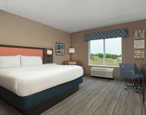 Bright day use king room with TV and work desk at Hampton Inn By Hilton Port Hope.