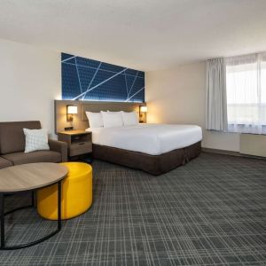 Day use room with work desk, TV, sofa and private bathroom at Comfort Inn & Suites Barrie.