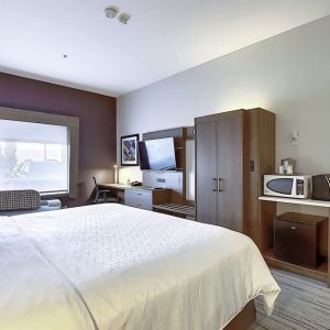 Spacious delux king room with TV and work desk at Holiday Inn Express & Suites Airport-Calgary.