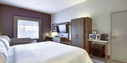 Spacious delux king room with TV and work desk at Holiday Inn Express & Suites Airport-Calgary.