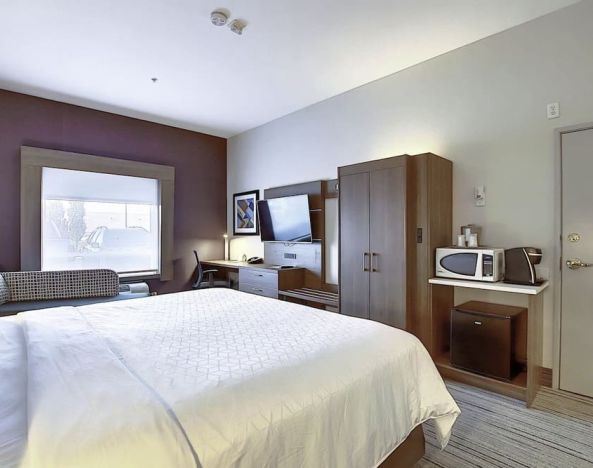 Spacious delux king room with TV and work desk at Holiday Inn Express & Suites Airport-Calgary.