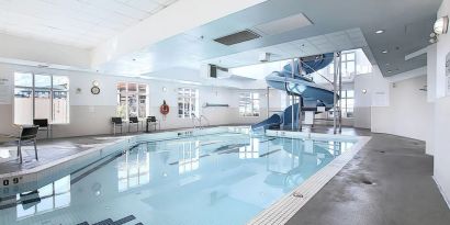 Indoor pool with lounge chairs at Holiday Inn Express & Suites Airport-Calgary.