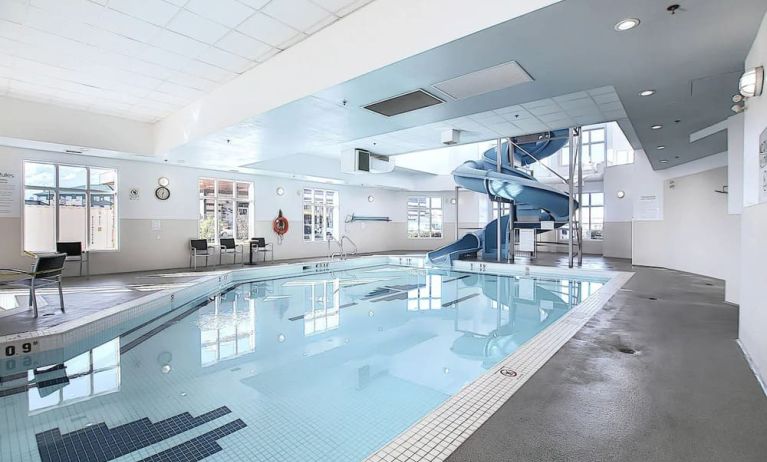 Indoor pool with lounge chairs at Holiday Inn Express & Suites Airport-Calgary.